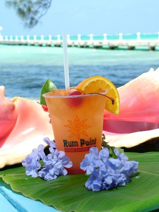  Rum Point Cayman drink with conch shells and flowers 