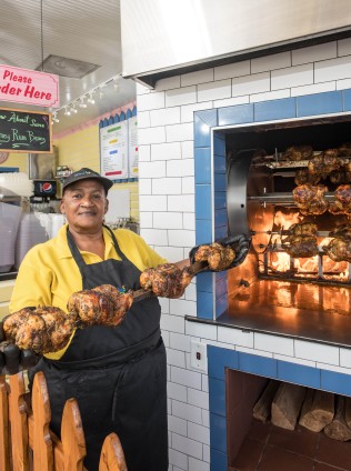  Woman holding chicken rotisserie 